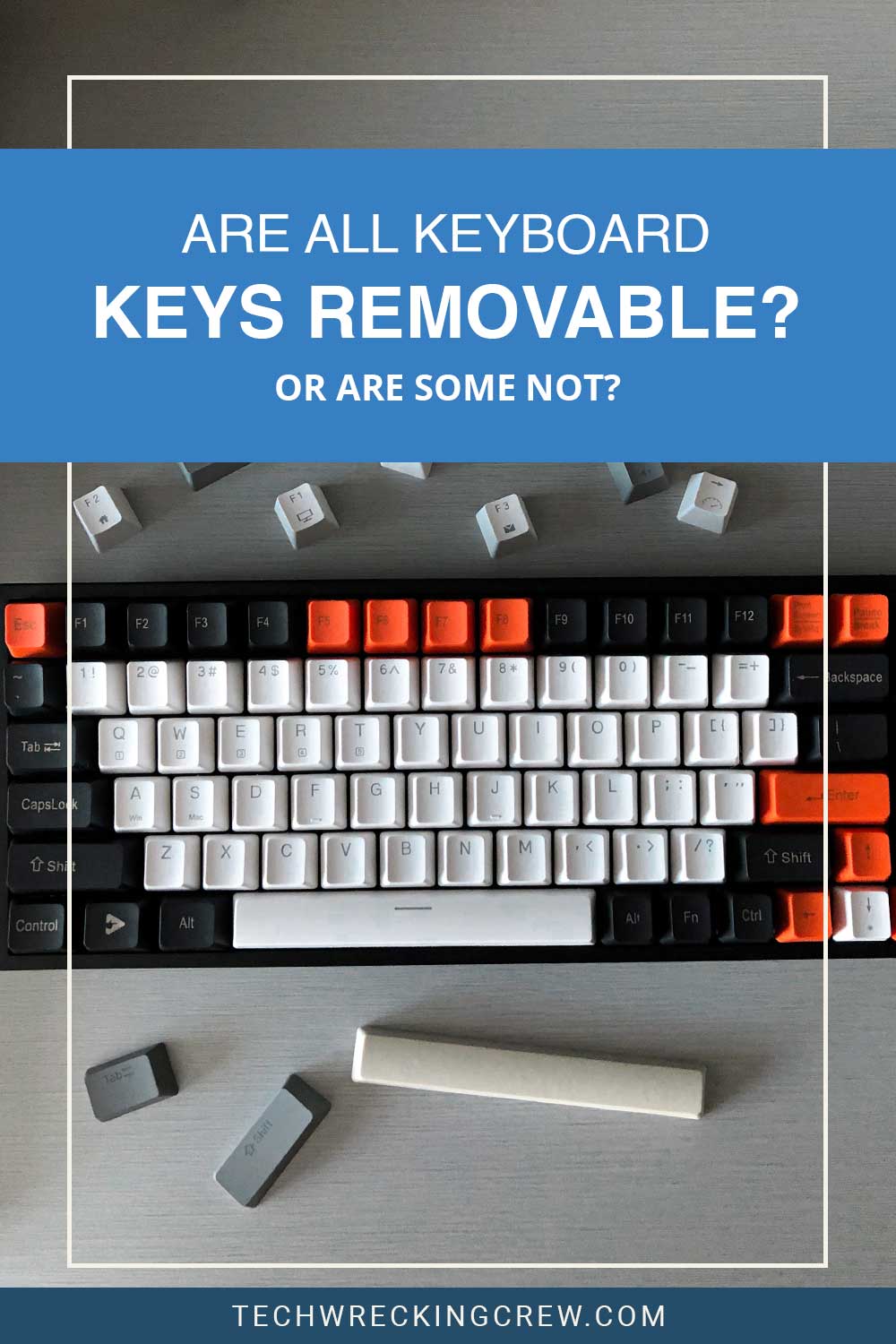 A keyboard and some loose keys on a grey surface - Are All Keyboard Keys Removable
