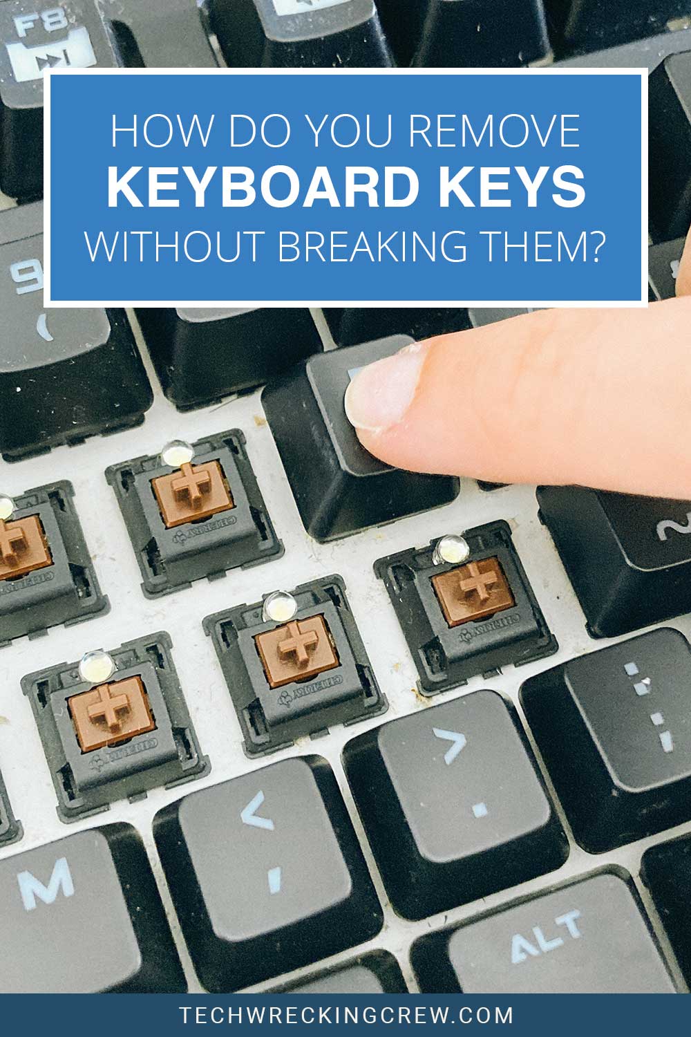 A finger on a Keyboard with some keys removed - How Do you Remove Keyboard Keys Without Breaking Them