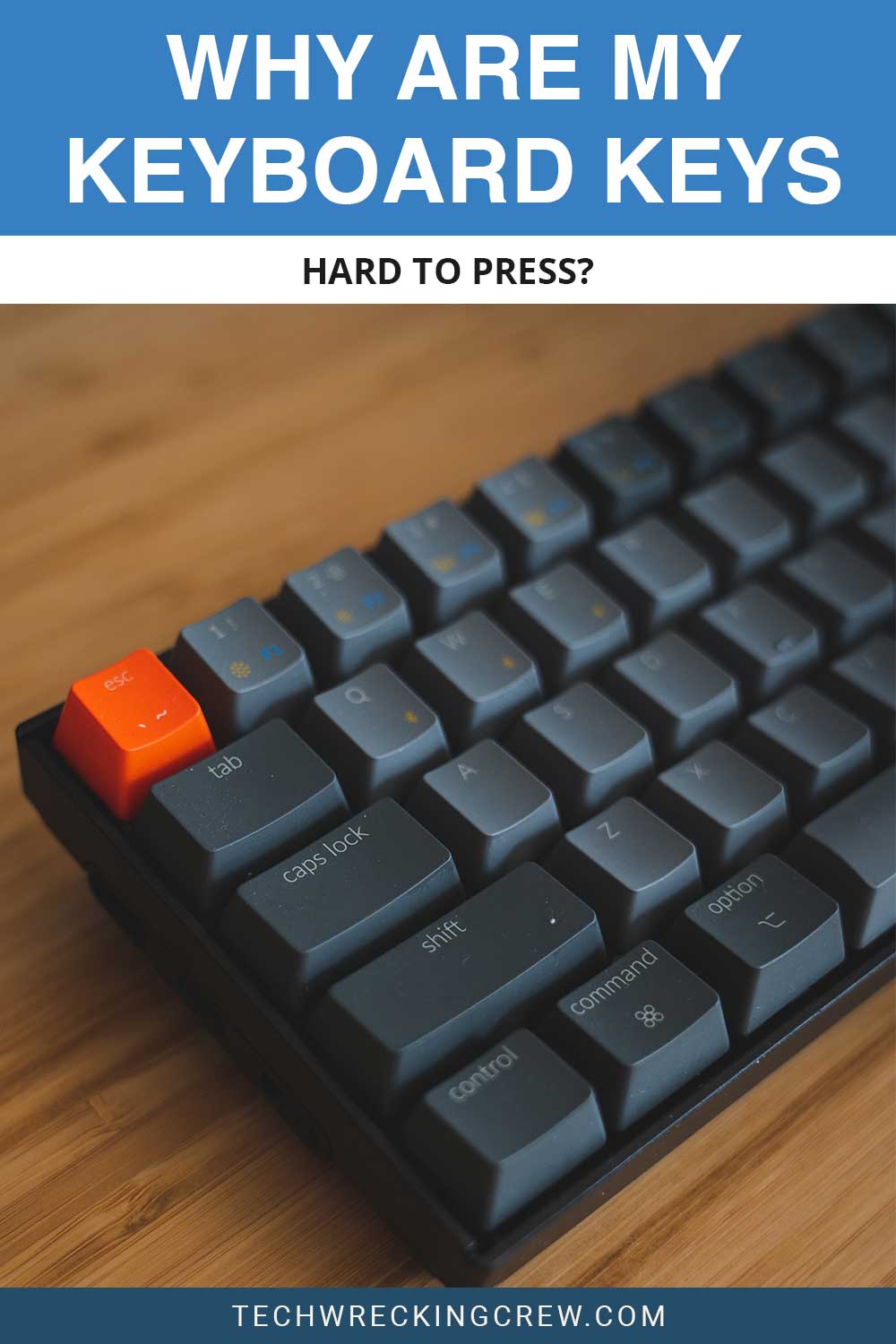 A black keyboard on a wooden surface - Why Are My Keyboard Keys Hard to Press